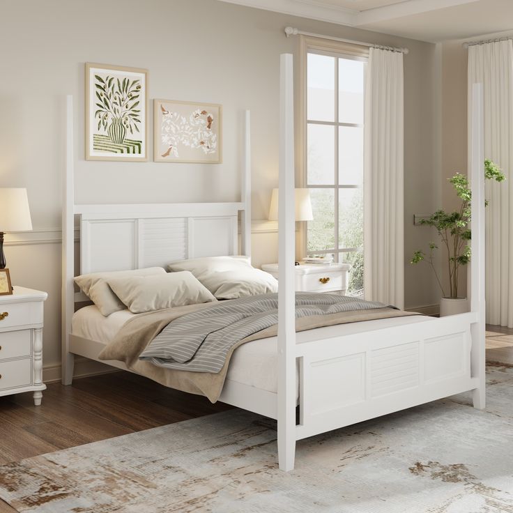 a white bed sitting in a bedroom on top of a hard wood floor next to a window