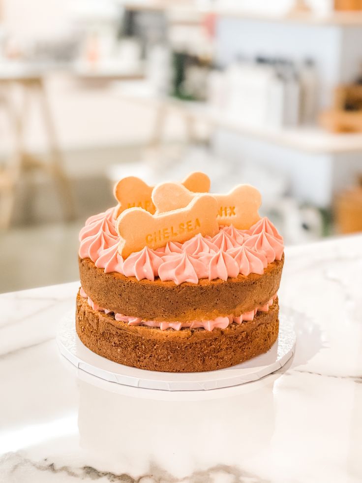 a close up of a cake on a table with other food items in the background