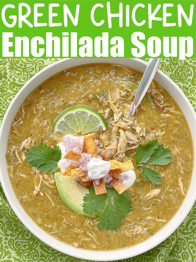 green chicken enchilada soup in a white bowl with cilantro, avocado and sour cream