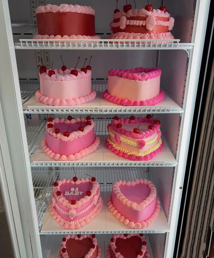 shelves filled with heart shaped cakes in a refrigerator