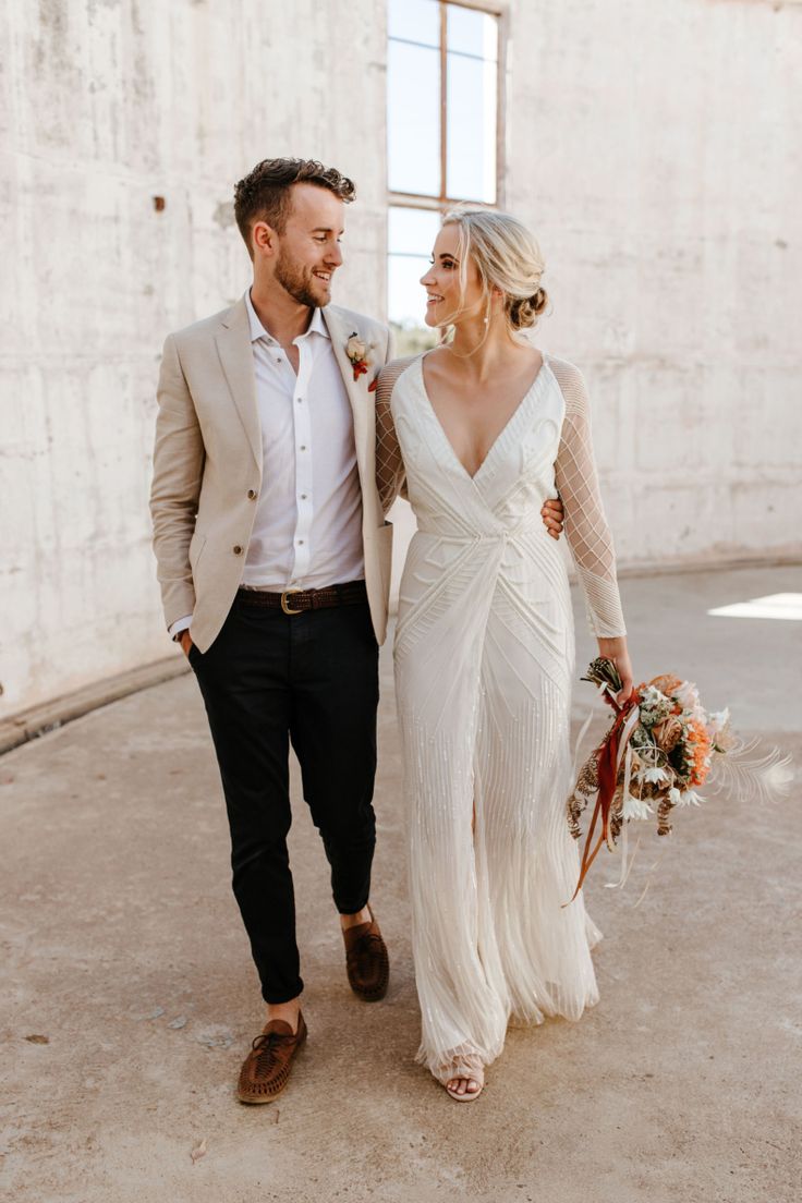 a bride and groom are walking together