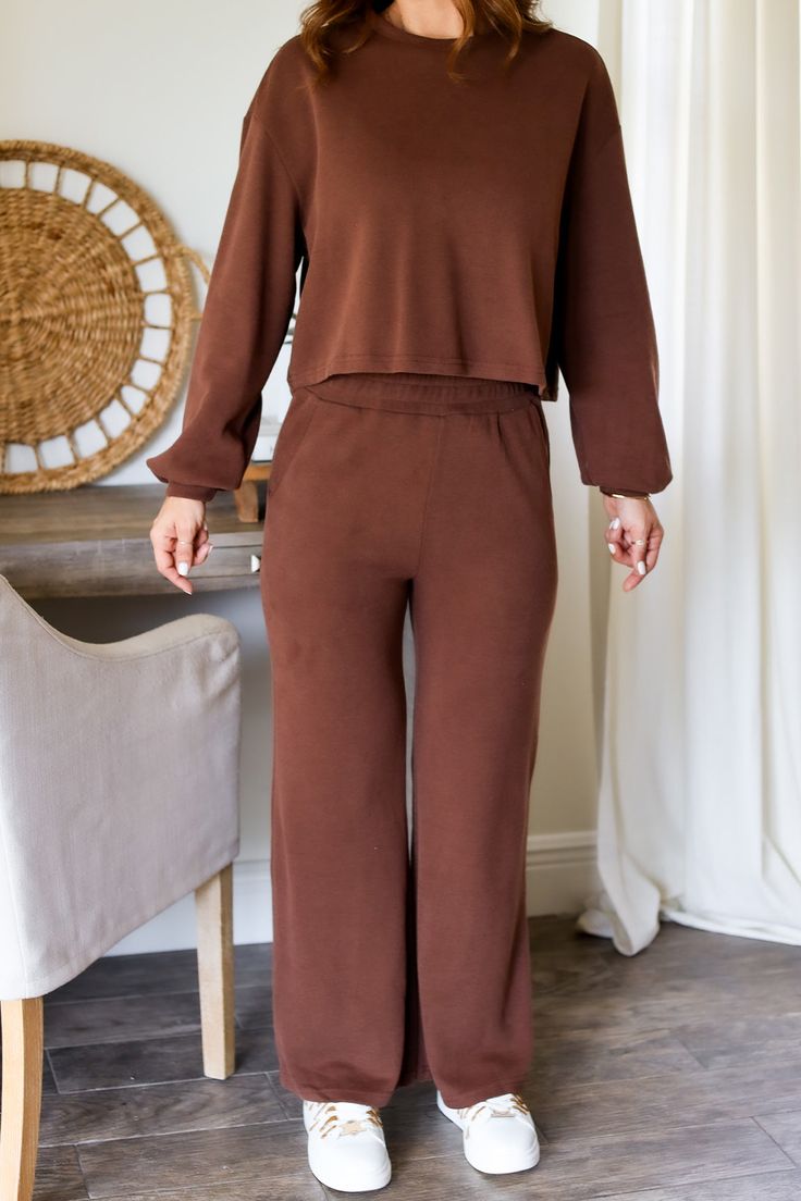 Unwind in style with the Carson Lounge Set. This versatile athleisure set is perfect for any occasion, whether you're lounging at home or on-the-go. Mix and match for endless outfit options. (Stretch, relax, and slay in comfort!) 65% cotton 35% polyester Color: Brown Athleisure Lounge Set Knit Sweat Set & Pants Round Neck Long Sleeves Elastic on waist Cropped Pants Functional pockets For a relaxed fit you can size up Model is wearing a size Small. She is 5'6". 135lbs. Bust: 34C Waist 26" Hips 36 Comfortable Lounge Sets For Fall, Comfortable Lounging Sets For Fall, Comfortable Sets For Lounging In Fall, Comfortable Fall Loungewear Sets, Cozy Activewear For Loungewear With Elastic Waistband, Cozy Relaxed Fit Activewear For Lounging, Comfy Cozy Fit Leisure Activewear, Comfy Cozy Fit Activewear For Leisure, Comfy Sweatpants For Relaxation In Fall