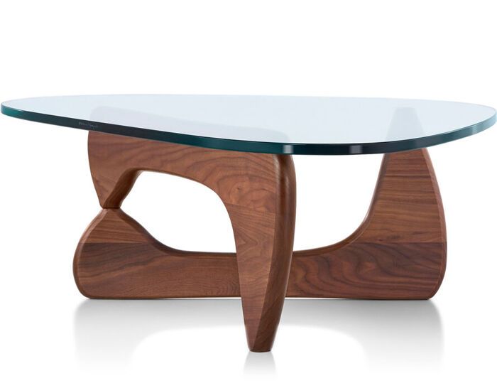 a glass and wood coffee table with an unusual design on the top, in front of a white background