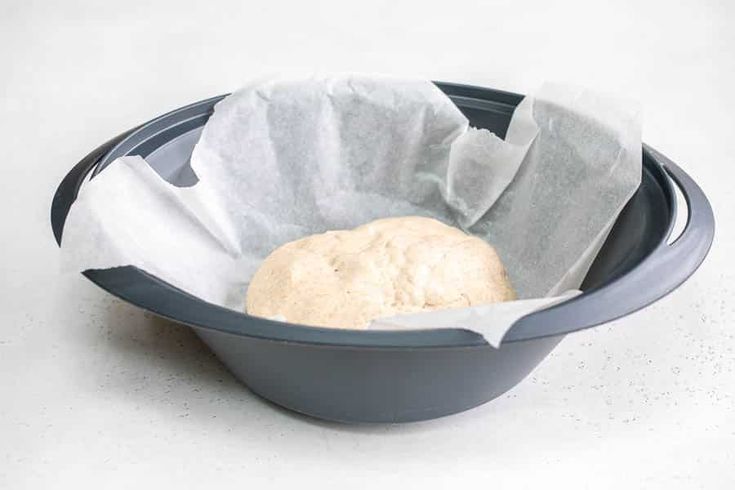 a bowl with some food inside of it on a table next to a paper towel