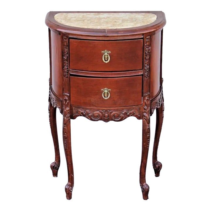 a wooden table with two drawers and marble top on one side, against a white background