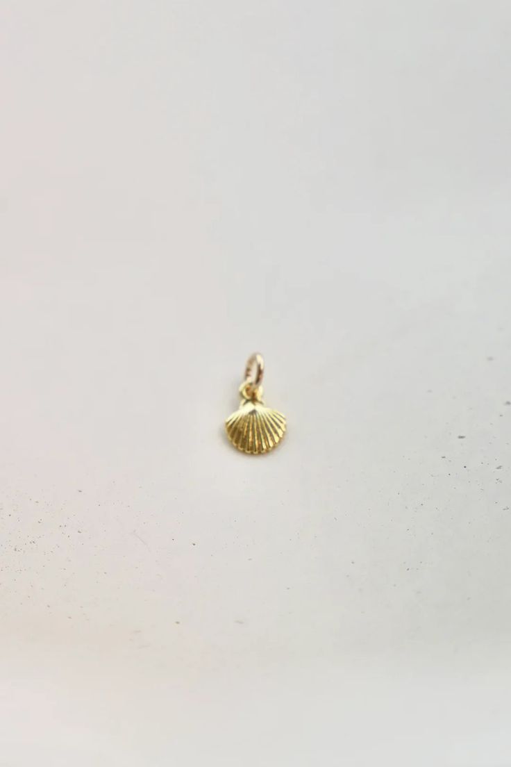 Get beachy with our Mini Shell Charm! This gold-plated charm adds a touch of seaside glamour to any outfit. Perfect for mermaids and sea lovers alike! (Not for actual use as a shell. Sorry, Ariel.) Dainty Shell-shaped Pearl Charm Jewelry, Dainty Shell-shaped Necklace With Pearl Charm, Beach Jewelry With Shell-shaped Pearl Charm, Shell-shaped Charm Necklaces With Pearl Charm For Beach, Shell-shaped Pearl Charm For Beach, Sun Bum, Wedge Flip Flops, Sea Lover, Dear John