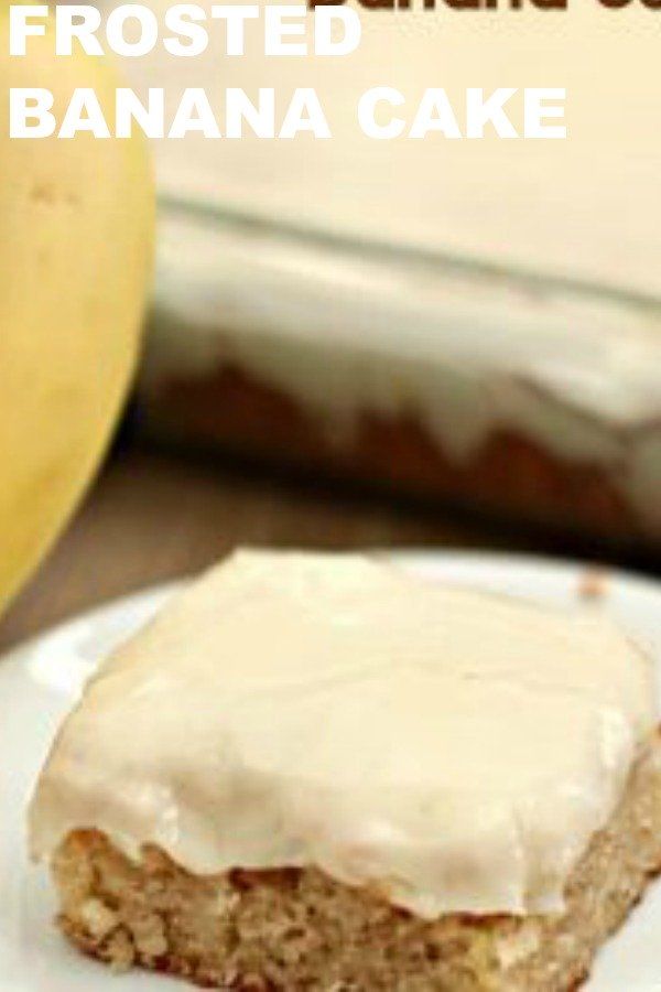 a close up of a piece of cake on a plate with a banana in the background