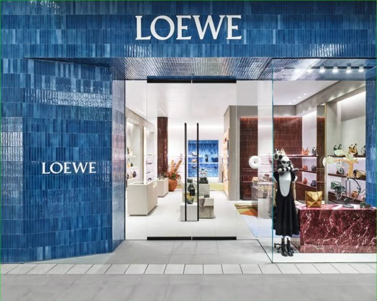 the storefront of loewe is decorated with blue tiles and glass doors that are open to let in light