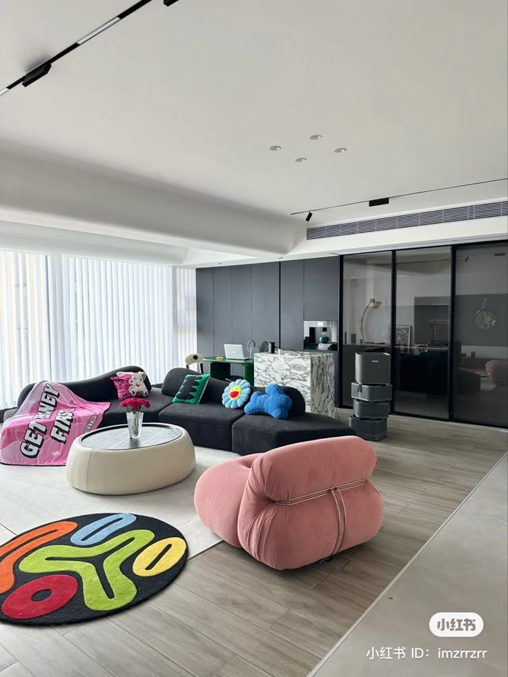 a living room filled with lots of furniture and decor on top of a hard wood floor