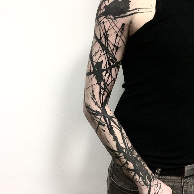 a man with black ink on his arm