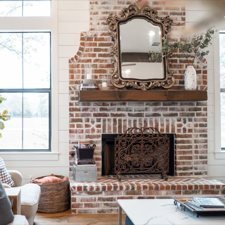 a brick fireplace with a mirror above it