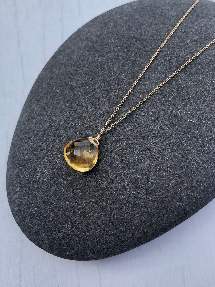 Yellow Topaz Necklace, November Birthstone, Yellow Topaz Teardrop Pendant, Solid 14k Gold, Real Gold Jewelry, Minimal Layering, Gift for her This beautiful dainty necklace features a flawless quality 8 mm micro faceted yellow topaz chubby teardrop wire wrapped in Solid 14k yellow gold. The yellow topaz pendant is suspended from a dainty solid 14k yellow gold chain. This is an everyday necklace, perfect for a gift for a girl born in November, as this is their birthstone. All element in this neckl Fine Jewelry Gold Drop Gemstones, Teardrop Topaz Yellow Gold Jewelry, Yellow Gold Topaz Teardrop Jewelry, Yellow Gold Briolette Gemstone Drop Necklace, Pear Shaped Citrine Gemstone Jewelry, Pear-shaped Citrine Gemstone Jewelry, Teardrop Topaz Necklace For Gift, Citrine Drop Gemstone Jewelry, Faceted Citrine Drop Jewelry