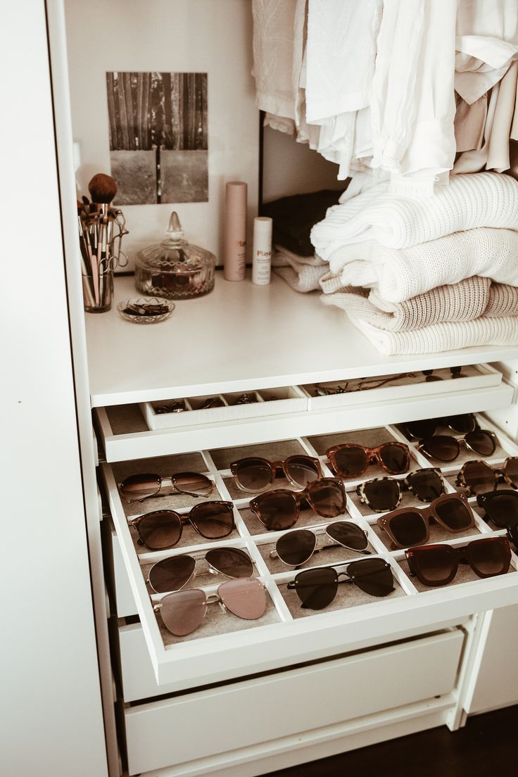 an open drawer with sunglasses on top of it