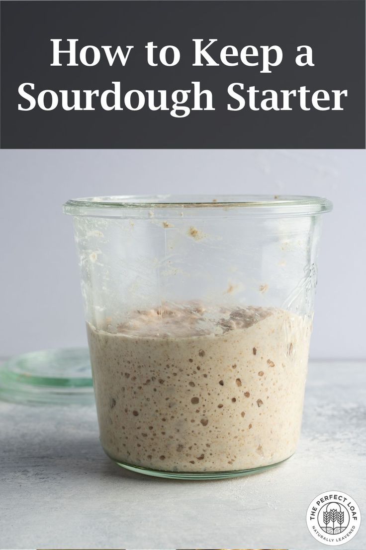 a glass jar filled with food sitting on top of a counter next to a spoon