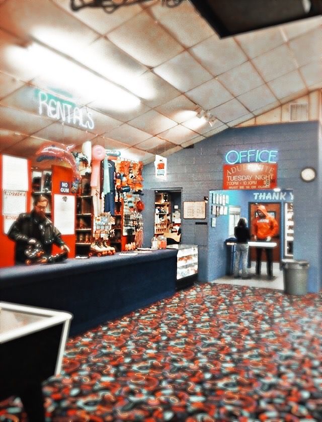 the inside of a store with an orange and blue carpet