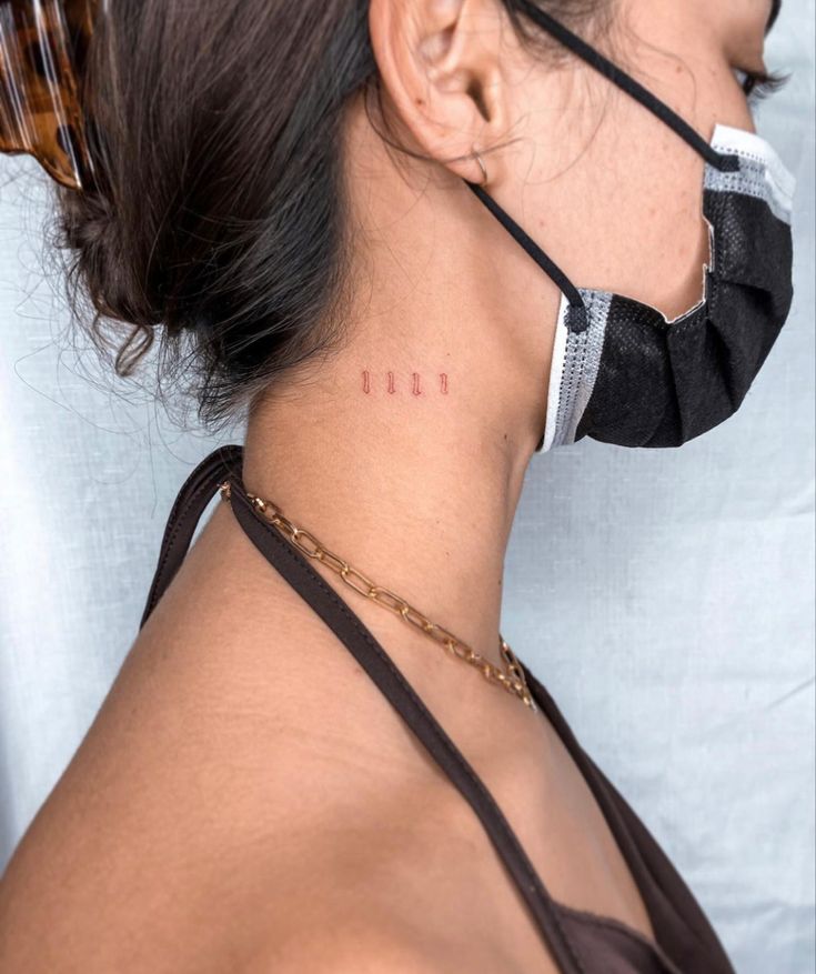 a woman wearing a black face mask with the word frisk written on her neck