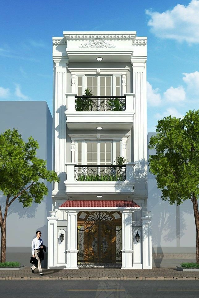 two people are standing in front of a tall white building with balconies on the second floor