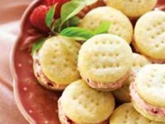 a red bowl filled with cookies and strawberries