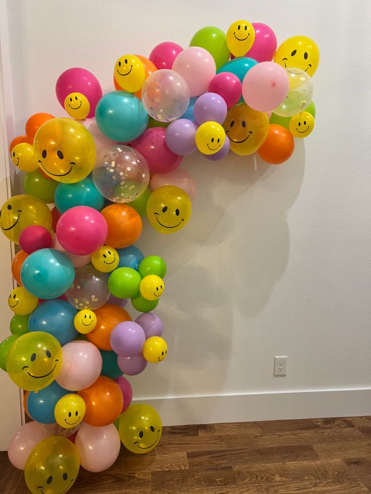 a number made out of balloons with smiley faces on them