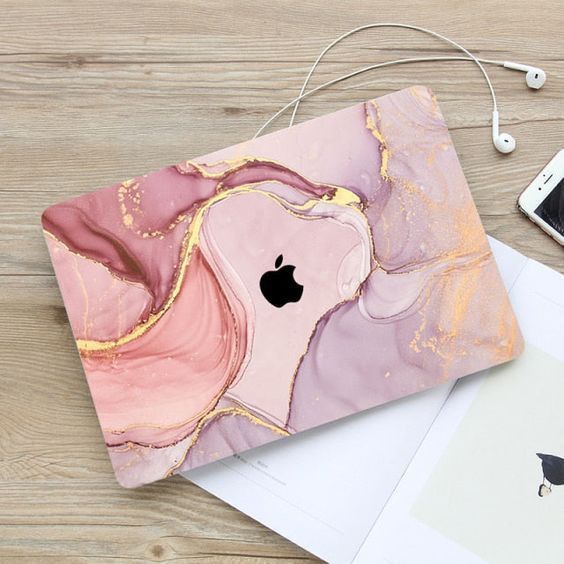 an apple laptop computer sitting on top of a wooden table