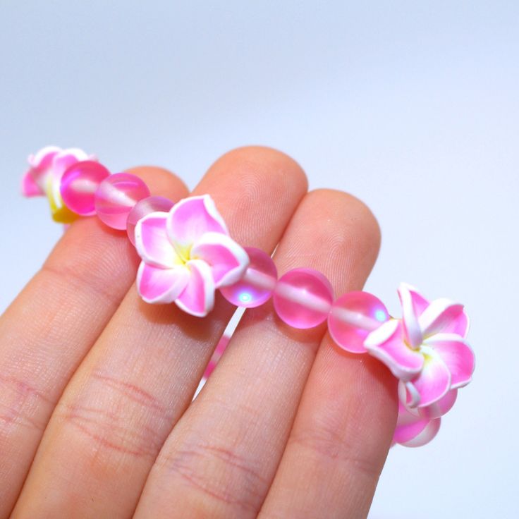 Product Description: - Pink Glass Beads - Pink/Yellow Polymer Clay Flower Beads - Clear Stretch Cord Cheap Flower Shaped Bracelets For Festivals, Flower Shaped Beaded Bracelets For Beach, Flower-shaped Colorful Beads Bracelet For Beach, Beach Flower Bracelets With Colorful Beads, Flower Shaped Colorful Beads Bracelets For Beach, Colorful Beaded Flower Bracelets For Beach, Pink Flower Charm Jewelry For Beach, Yellow Flower Bracelets For Beach, Yellow Flower Bracelets For The Beach