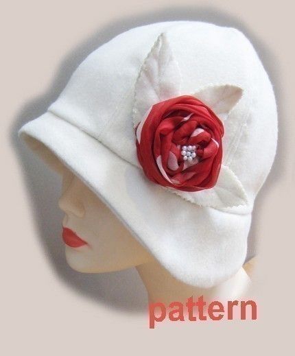 a white hat with a red flower on it