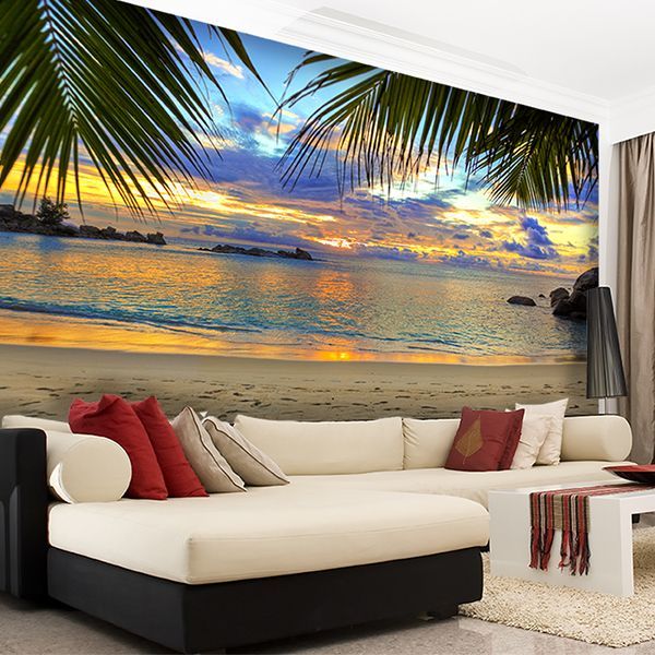 a living room with a couch and large painting on the wall behind it that has palm trees