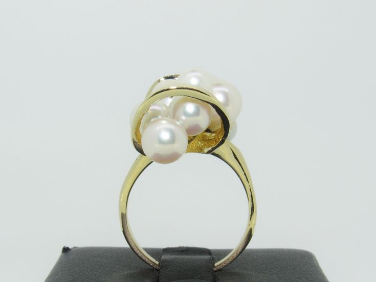 This unique piece features 10 luscious (approx. 4.92 mm to 6.75 mm) Pearls. Set in 14K yellow gold. This ring is in excellent pre-owned vintage condition. The size is a 7.5. Total weight is approx. 9.9 grams. (T6 * MJP032592) Please review all photos before purchasing and feel free to ask questions about the item :) For more information you can call us at 360-657-5276. We are sorry but we do NOT offer INTERNATIONAL SHIPPING! Payment due upon checkout to avoid shipping delays and loss of purchase Formal Yellow Gold Pearl Ring With High Luster, Formal High Luster Yellow Gold Pearl Ring, Formal 14k Gold Pearl Ring With High Luster, Formal Yellow Gold Rings With High Luster, High Luster Yellow Gold Rings For Formal Occasions, Formal High Luster Yellow Gold Rings, Elegant Yellow Gold Rings With High Luster, High Luster Yellow Gold 14k Ring, Timeless High Luster Rings For Formal Occasions