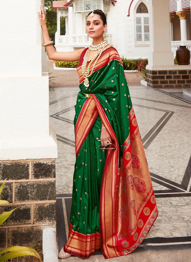 Wrap yourself in elegance with our Green Silk Woven Zari Broad Border saree. The multi-thread weaving creates a soft, luxurious feel perfect for any occasion. Comes with a contrasting red blouse to complete the look. Stand out in style in USA, UK, and Canada. The unstitched blouse can be customized unto 44 inches. Do Note: All the accessories shown are for styling purpose only. Slight color variation may occur due to photographic reasons. Fall and Pico : Done Drapping Saree(Ready to wear) : On R Red Blouse Saree, Silk Saree For Wedding, Red Saree Blouse, Paithani Silk Saree, Paithani Saree, Paithani Sarees, Purple Saree, Orange Saree, Indian Saree Blouse