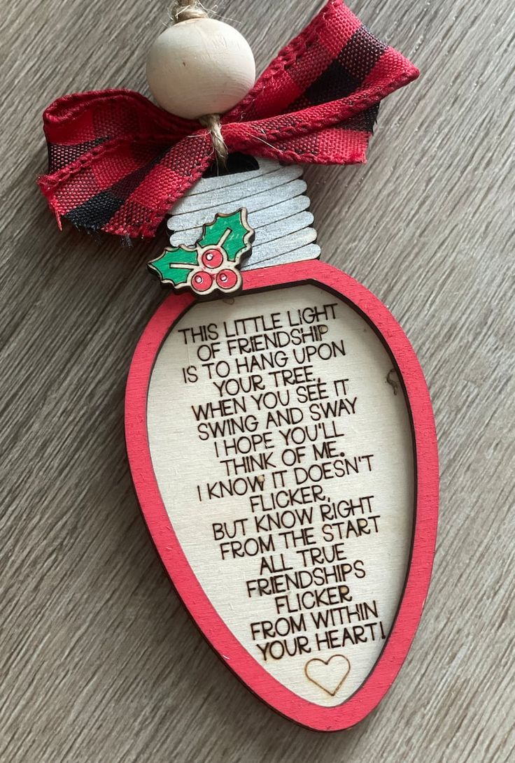 an ornament with a poem on it and a red ribbon around the edge