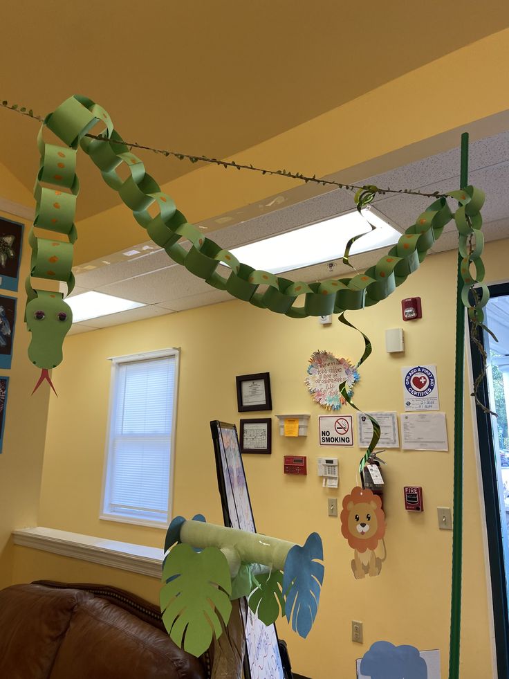 the room is decorated with green streamers and pictures on the wall, along with other decorations