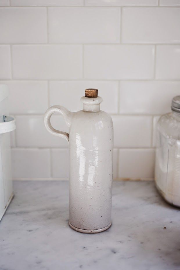 a white jug sitting on top of a counter