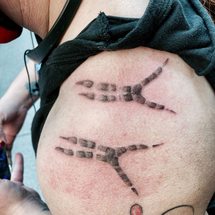 a woman with a tattoo on her stomach that has the word love spelled in cursive writing