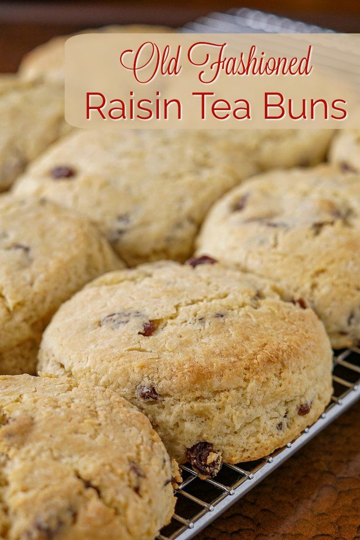 old fashioned raisin tea buns on a cooling rack with text overlay that reads old fashioned raisin tea buns