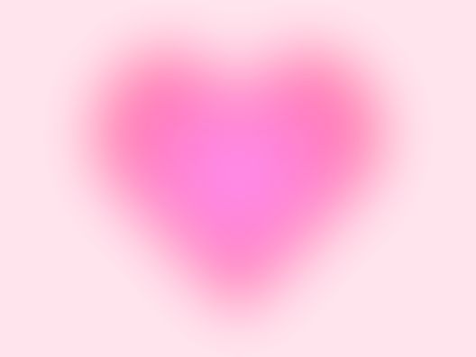 a blurry pink heart on a light pink background