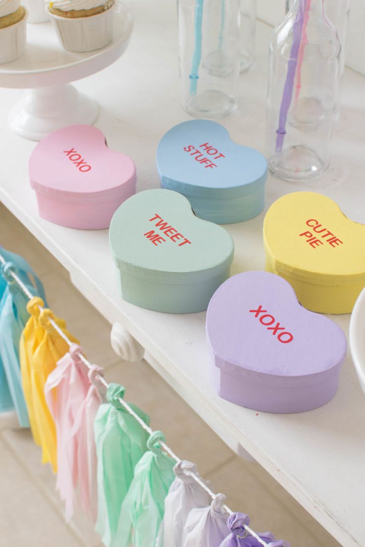 several heart shaped candy boxes on a table