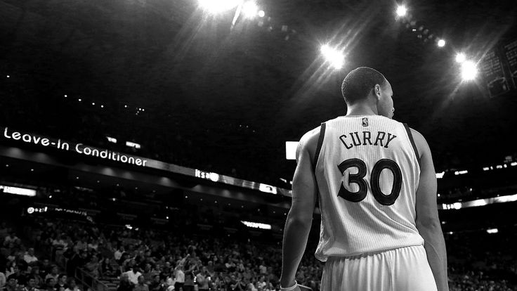 a basketball player is standing in front of the crowd