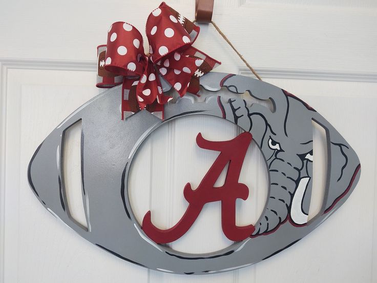 a metal door hanger with a red and white bow on it's side