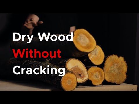 the words dry wood without cracking are in front of a pile of cut logs