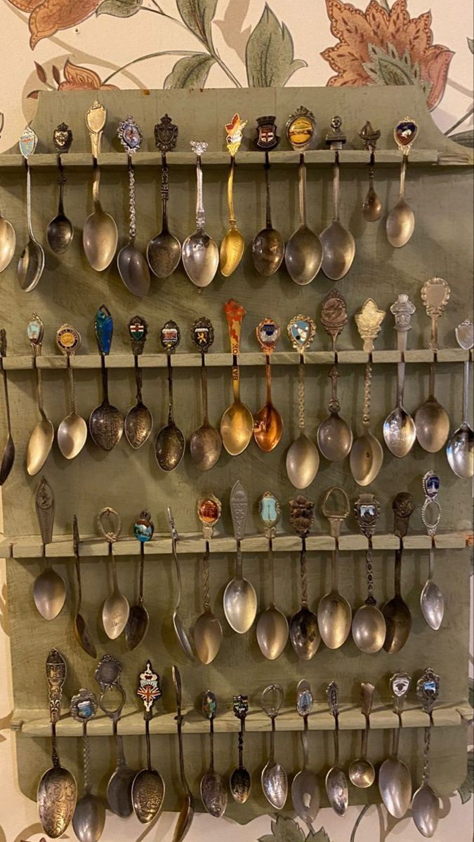 a wall mounted rack with spoons and spoons on it