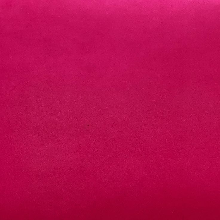 a bright pink pillow is shown on a white background