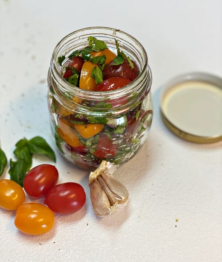 a jar filled with lots of different types of vegetables