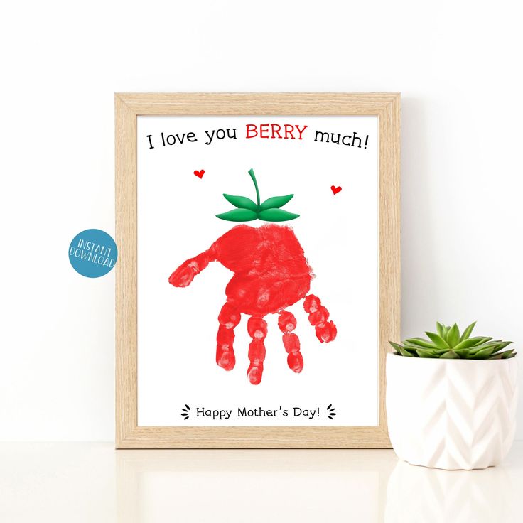 a handprint is shown in front of a potted plant and a framed card