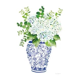 a blue and white vase with flowers in it