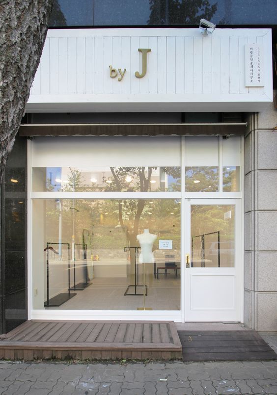 the front entrance to jvj's clothing store with mannequins on display