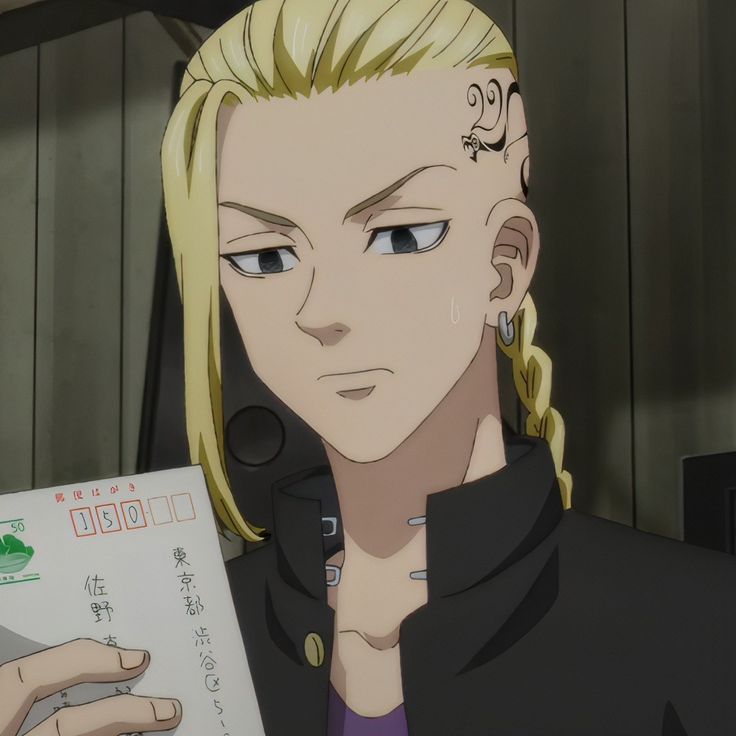 a blonde haired man holding a piece of paper