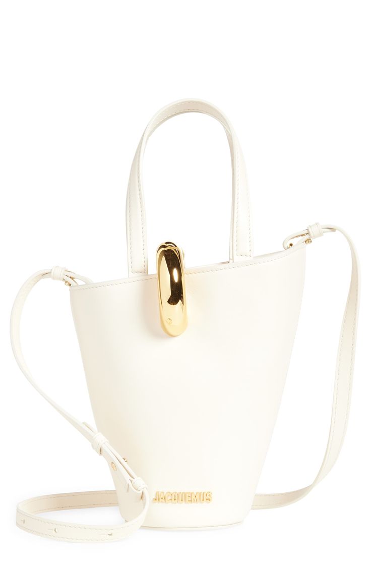 This asymmetric bucket bag is made in Italy from smooth leather and features a golden-ring magnetic clasp and matching logo hardware. Magnetic closure Top carry handles; removable, adjustable shoulder strap Interior zip pocket Structured silhouette with flat base for stability Cotton lining Leather Made in Italy Designer Handbags Formal White Bucket Bag, White Chic Formal Bucket Bag, Chic Bucket Bag With Round Handle, Modern Gold Top Handle Bucket Bag, Chic White Formal Bucket Bag, Chic Office Bucket Bag With Gold-tone Hardware, Modern Bucket Bag With Brass Hardware For Daily Use, Chic Gold Bucket Bag, Gold Bucket Bag