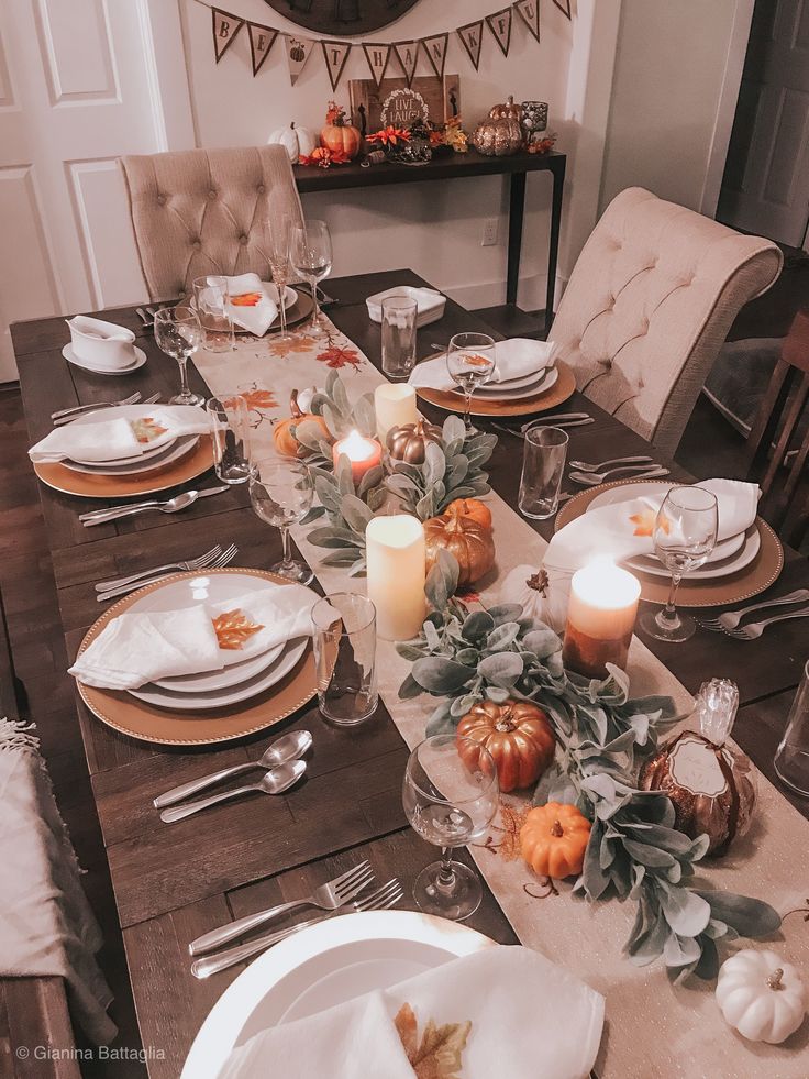 a dining room table set for thanksgiving dinner