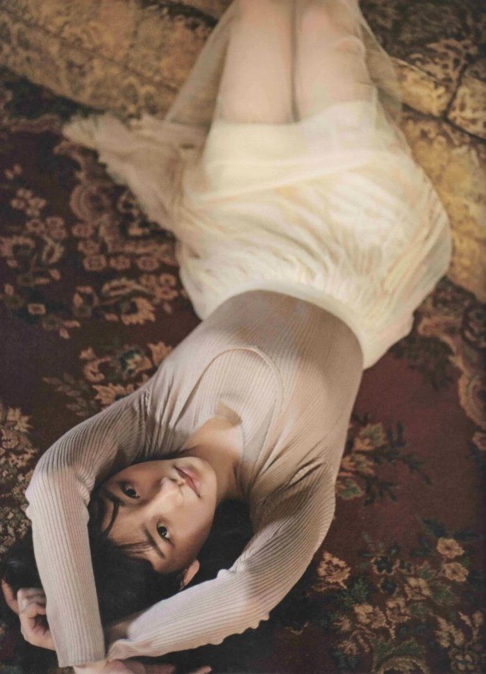 a woman is laying on the floor with her legs spread out in front of her