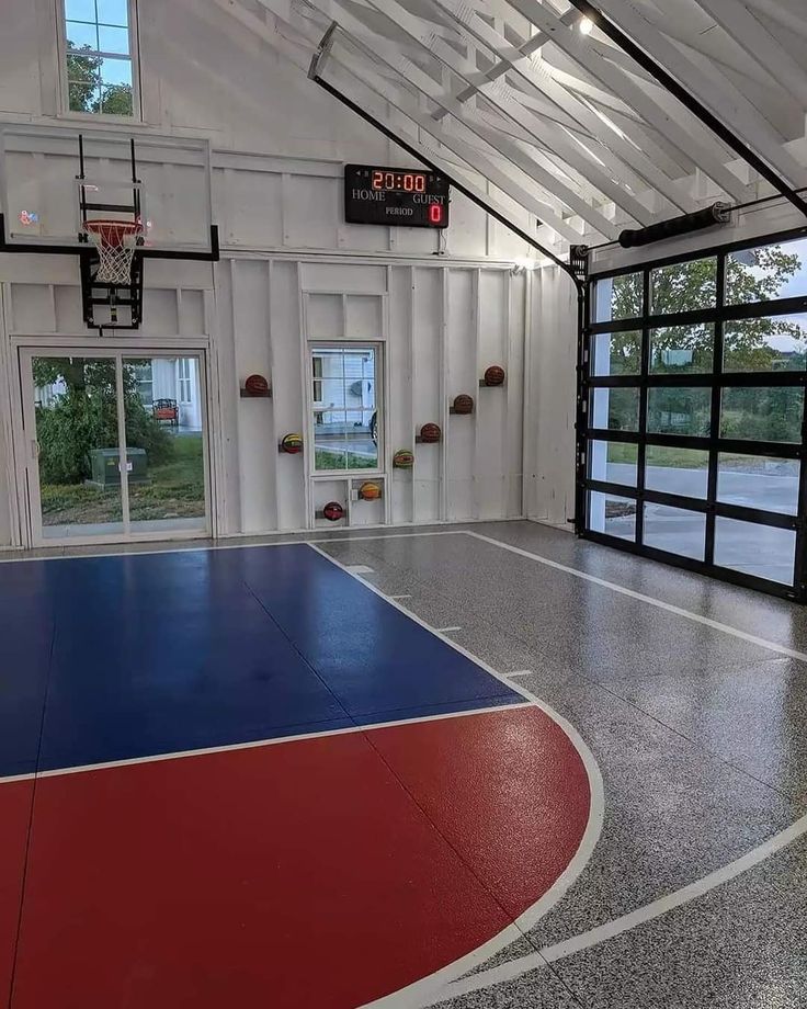 an indoor basketball court is painted red, white and blue